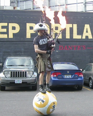 Guy Plays STAR WARS Theme Song With Flaming Bagpipes While Balancing on BB-8 Droid