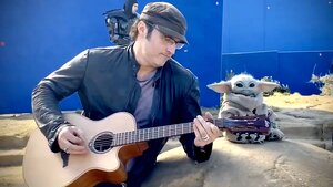 Baby Yoda Enjoys a Little Jam Session with Director Robert Rodriguez on the Set of THE MANDALORIAN 